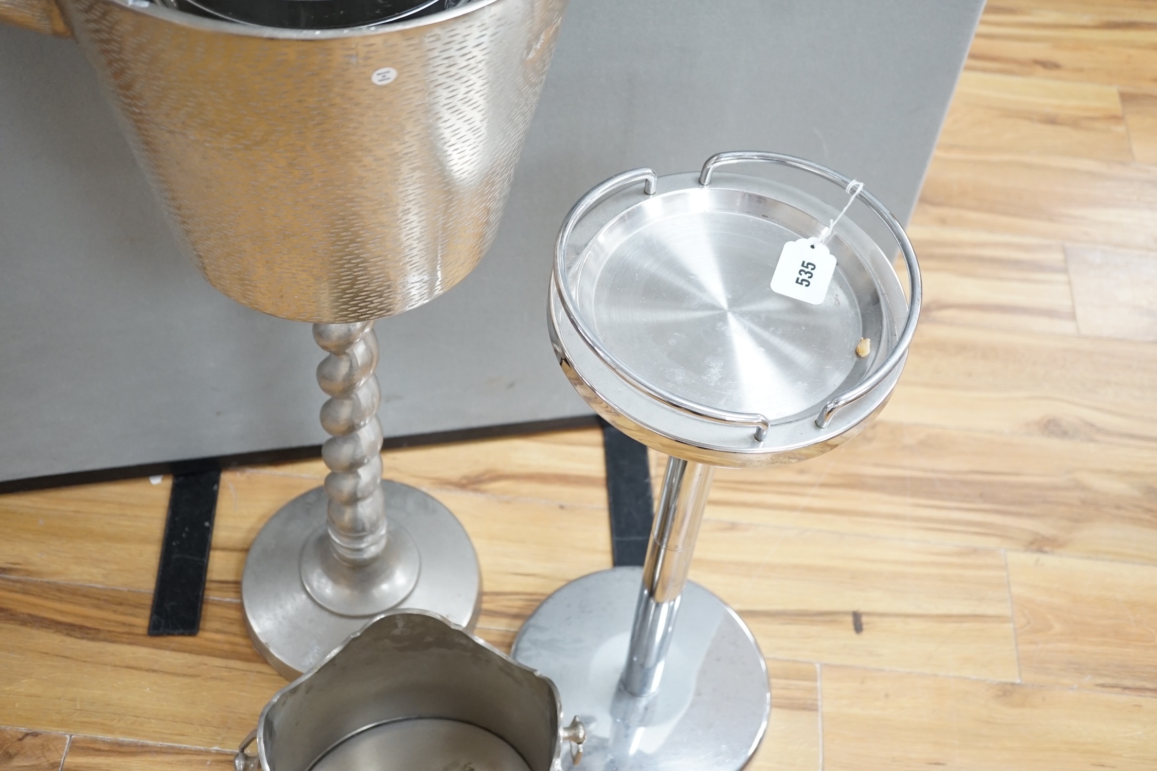 An aluminium stag handled floor standing wine / champagne cooler, another and three table top wine coolers, tallest 86cm high